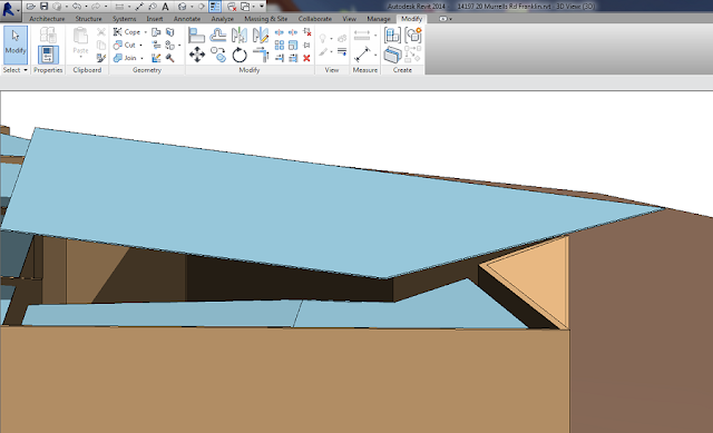 Revit 3D view of a skillion roof, shown in blue, sloping over brown walls with a 45 degree edge - the roof this gutter will be added to